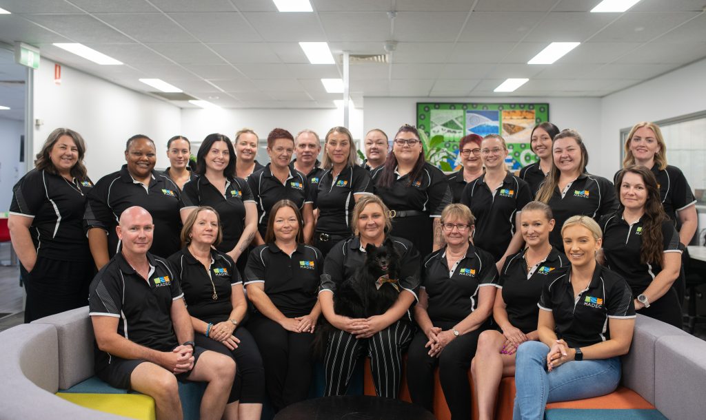 A group of MADEC staff posing for a photo