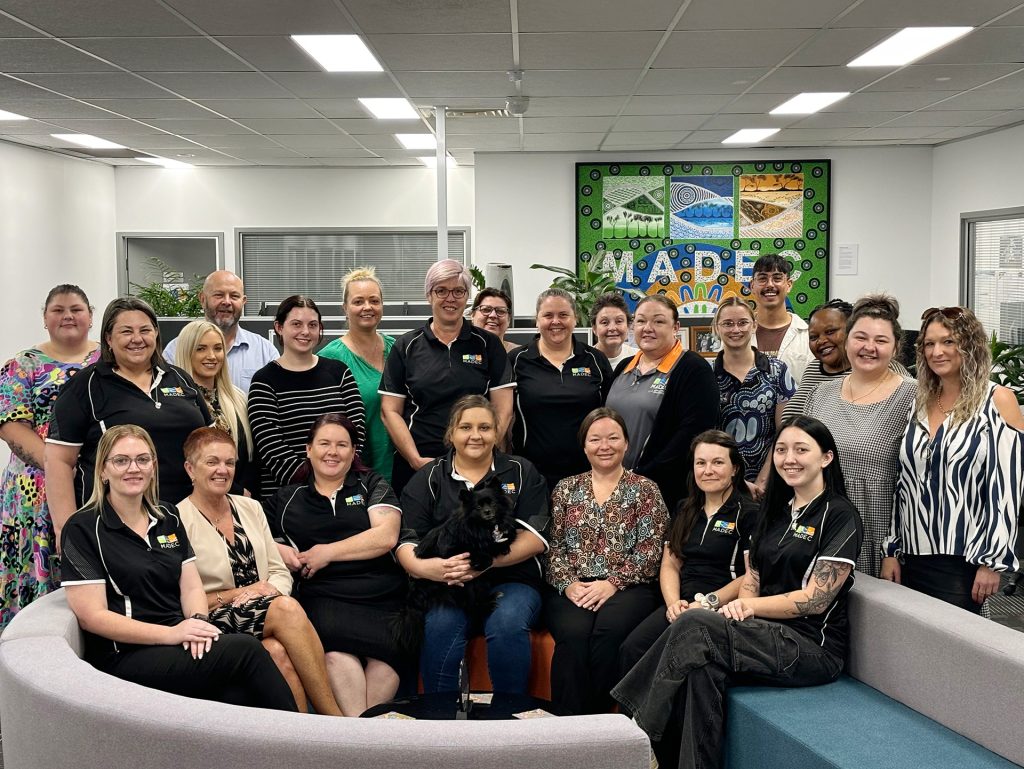 A group of staff members in the MADEC office